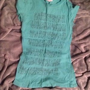 Blue shirt with drawings of little animated girls